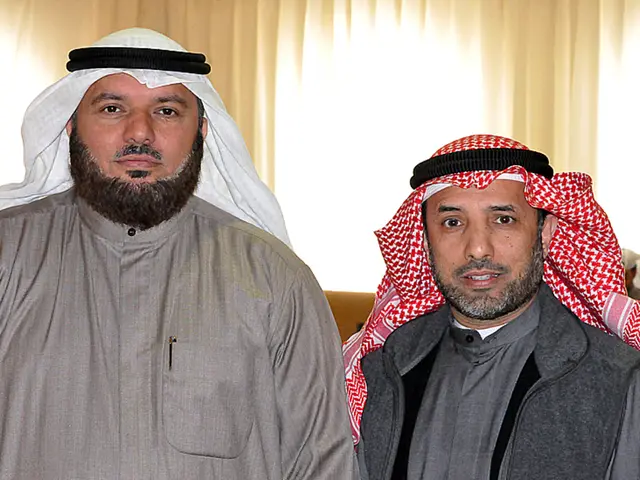 In this image we can see people wearing turbans. In the background there are blinds.