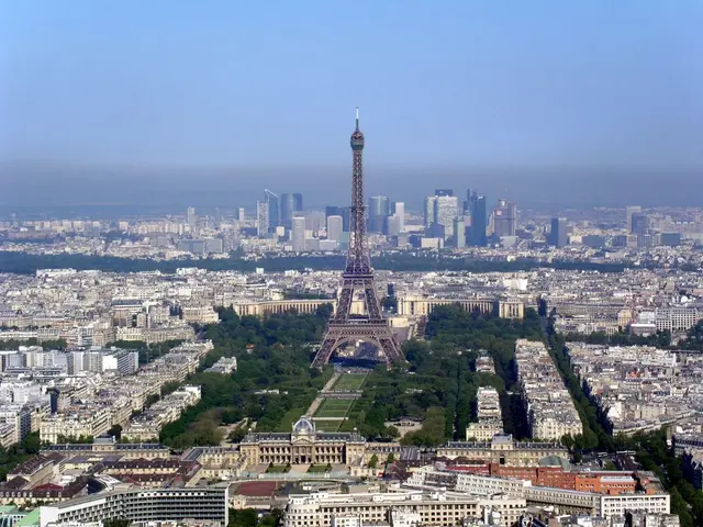 In this image, I can see an eiffel tower. This is the view of the city with skyscrapers and...