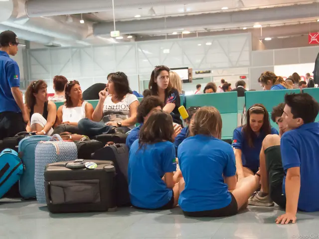 It is an airport, the picture is inside an airport, there are many people waiting for the flights,...